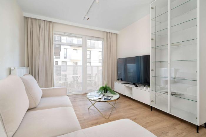 Spacious Apartment with a Balcony Close to the Airport by Noclegi Renters
