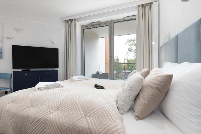 Mazowiecka Apartments Close to the Beach Access to Swimming Pool Sauna & Jacuzzi Parking by Noclegi Renters - image 20