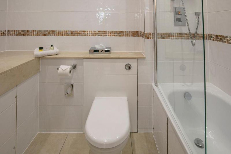 Economy room with single bed and internal window to corridor image 3