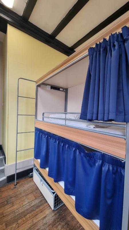 Bed in 18-Bed Mixed Dormitory Room with External Shared Bathroom image 4