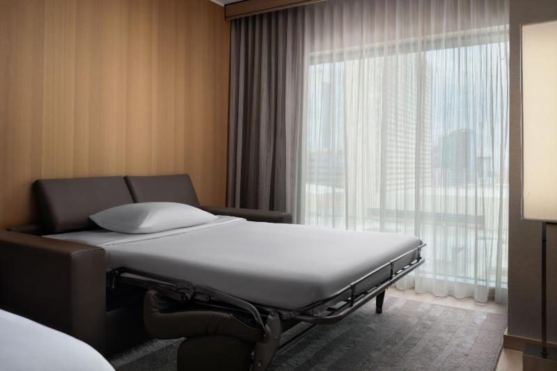 King Guest Room with Sofa Bed and City View image 3