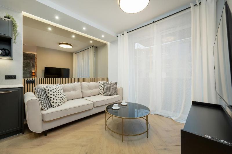 Black and Beige Apartment with Balcony and Parking in Wrocław by Noclegi Renters - image 1