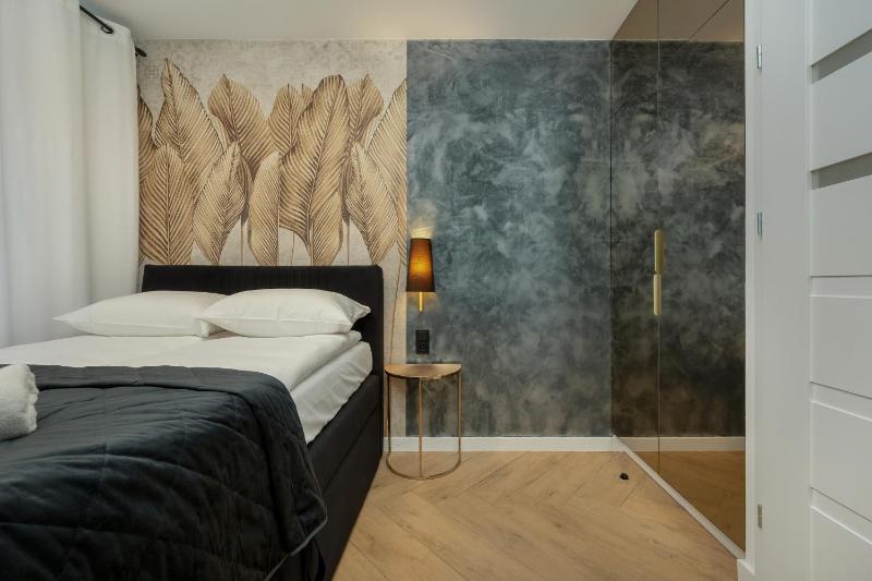 Black and Beige Apartment with Balcony and Parking in Wrocław by Noclegi Renters - image 12