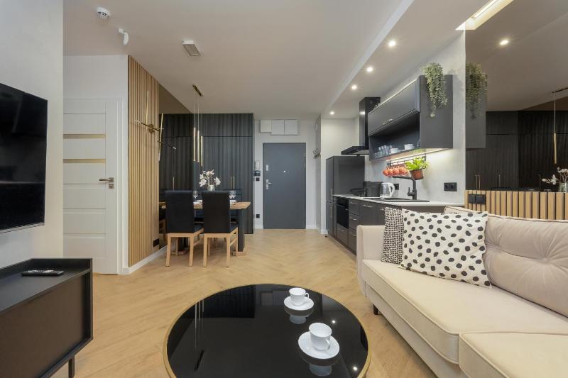 Black and Beige Apartment with Balcony and Parking in Wrocław by Noclegi Renters - image 21