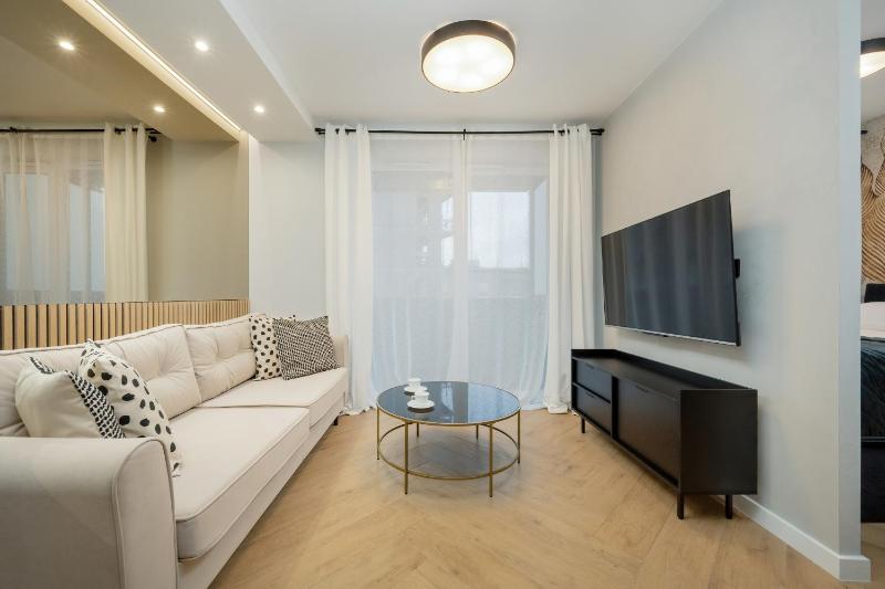 Black and Beige Apartment with Balcony and Parking in Wrocław by Noclegi Renters - image 13