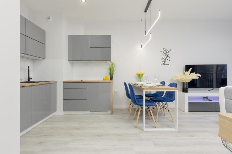 Dark Blue and Grey Apartment with Pastel Bedroom in Warsaw by Noclegi Renters - image 16