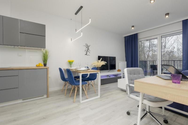 Dark Blue and Grey Apartment with Pastel Bedroom in Warsaw by Noclegi Renters - image 12