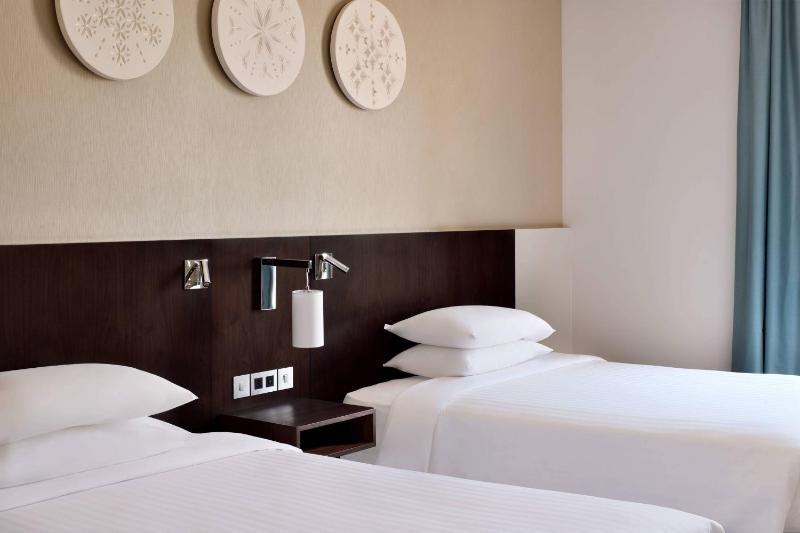 Deluxe Guest Room with Two Double Beds and Courtyard View