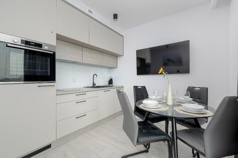 Modern Apartment with Balcony and Parking by Noclegi Renters - image 19