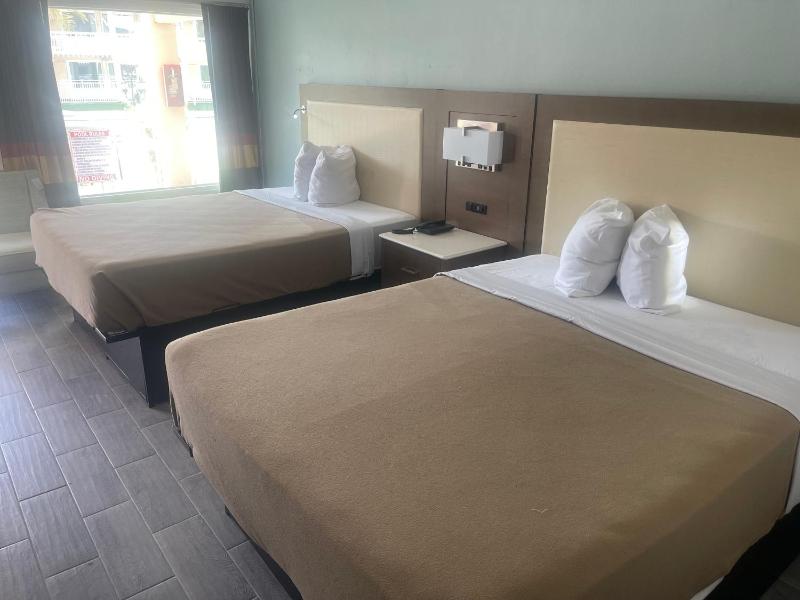 Quadruple Room with Two Queen Beds and Pool View - Non Smoking image 3