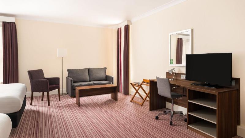 Premium Queen Room with Two Queens and One Sofa Bed image 1
