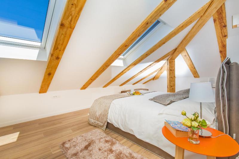 One-Bedroom Apartment with Balcony - Attic image 2