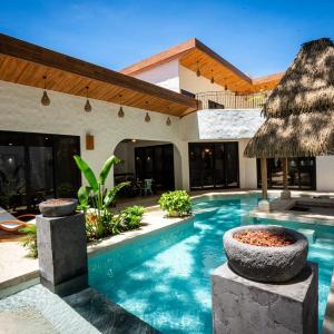 Bohemian Tropical Villa with a Tiki-Style Swimming Pool & Swim-Up Bar with an Attached Studio Apartment