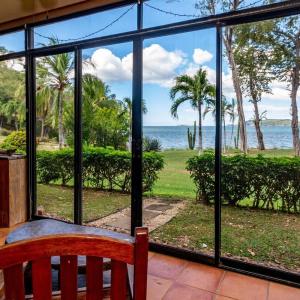 Beachfront Condo with Warm, Rustic Interiors & Direct Access to Playa Flamingo