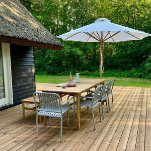 Be Surrounded By Trees In A Thatched Cottage