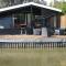 Modern chalet in a small park with a fishing pond