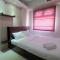 Homey and Relaxing 2BR Green Pramuka City Apartment By Travelio