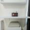 Modern White Studio at Springlake Summarecon Bekasi Apartment By Travelio