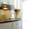 Furnished Studio with Comfortable Design Green Pramuka Apartment By Travelio