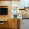 Furnished Studio with Comfortable Design Green Pramuka Apartment By Travelio