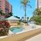 Beachfront condo building with pool, tennis and views