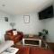 Orchard Lodge -Coastal Retreat, new build, village views, private garden and terrace