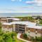 Cheery coastal condo with balcony, AC, W/D, 2 pools, grills, & beach access