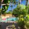 An Island Getaway at Palm Tree Villas - Холмс-Бич