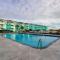 1st-floor pool-view condo with outdoor pool, beach access, balcony, W/D, & AC