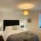Above the Bay - Enclosed garden apartment with parking