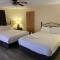 JI7, A Queen Guest Room at the Joplin Inn at entrance to the resort Hotel Room