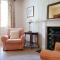 Traditional farm cottage with woodburner by stream