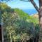 Villa La Lecceta surrounded by greenery and sea view with sunset