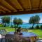 Apartment on Lake Garda with pebble beach pier for boat three swimming pools