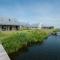 Modern design lodge with combi microwave, in national park - Tholen