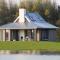 Modern design lodge on the water located on a holiday park in a national park - Tholen