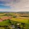 Corn Barn at East Trenean Farm -Luxury Cornish Barn Conversion sleeping 8 with hot tub, private garden, rural views and EV facilities