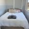 Sweet Cute blue tiny home with Pool and 2 minute drive to the beach