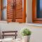 Open the Classic Wooden Shutters at a Cozy City Nest