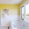 Pleasant ocean view home with balcony, rocking chairs, soaking tub, AC, & W/D