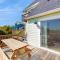 Pleasant ocean view home with balcony, rocking chairs, soaking tub, AC, & W/D
