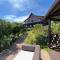 Peaceful guest suite with balcony views and garden setting
