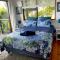 Peaceful guest suite with balcony views and garden setting