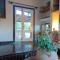 Villa La Lecceta surrounded by greenery and sea view with sunset