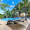 Modern Split-Level 2-Bedroom Condo with Pools, Terrace & Easy Beach Access