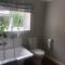 En-suite with double bed on mezzanine and desk in family home - Hertford