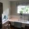 En-suite with double bed on mezzanine and desk in family home - Hertford