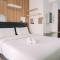 Simply Look Studio at Amazana Serpong Apartment By Travelio