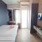 Homey and Cozy Living Studio Amartha View Apartment By Travelio - Семаранг