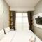 Homey and Minimalist 1BR Vasanta Innopark Apartment By Travelio